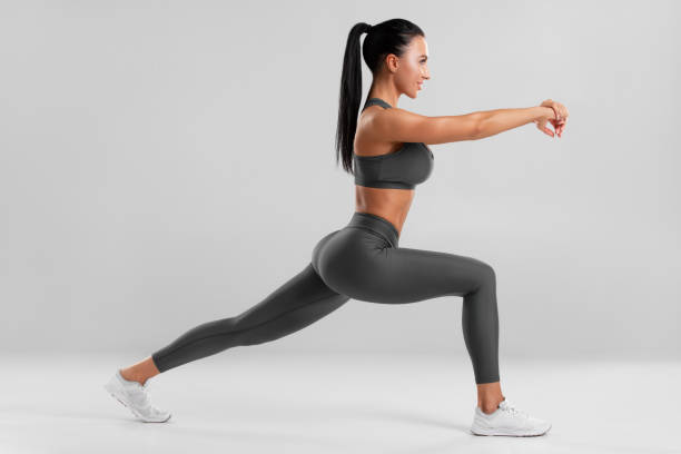 istock Fitness woman doing lunges exercises for leg muscle training. Active girl doing front forward one leg step lunge exercise 1397188791