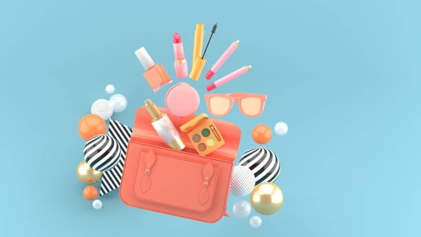 Cosmetics from the handbag surrounded by colorful balls on a blue background.-3d rendering."n stock photo