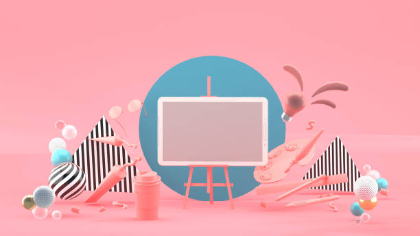 istock Tablets on canvas frames surrounded by stationery on a pink background.-3d rendering.