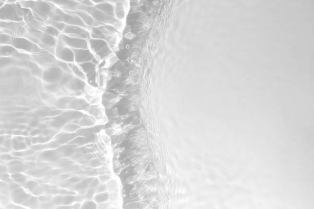 istock Water texture with sun reflections on the water overlay effect for photo or mockup Organic light gray drop shadow caustic effect with waves and ripples. Banner with copy space. 1397189740