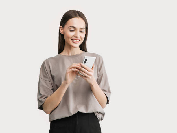 istock Happy smiling girl using smart phone, isolated 1397190011