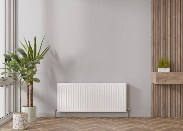 White heating radiator on grey wall in modern room. Central heating system. Free, copy space for your text. 3D rendering. White heating radiator on grey wall in modern room. Central heating system. Free, copy space for your text. 3D rendering heating engineer stock pictures, royalty-free photos & images