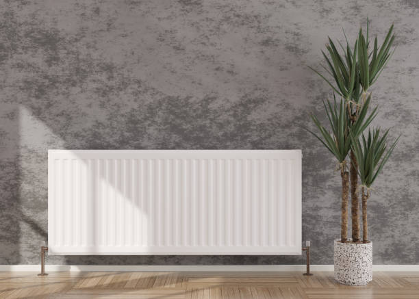 istock White heating radiator on grey concrete wall in modern room. Central heating system. Free, copy space for your text. 3D rendering. 1397190678