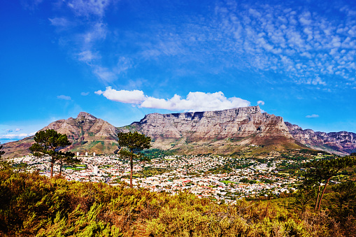 Residential areas of the city of Cape Town, South Africa, nestle in the hollow below Table Mountain known as the City Bowl. The mountain on the left is called Devil's Peak. To the right is the range known as the Twelve Apostles.