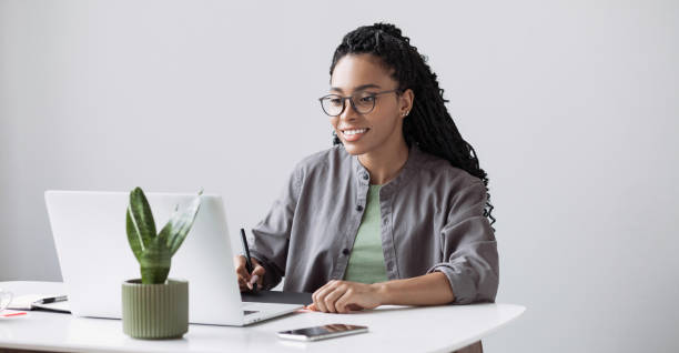 istock Woman working from home, having meeting online. Designer using graphics tablet in office 1397197377