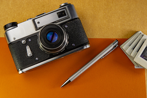 Film camera, pen and slides. Business concept.