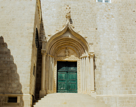 Green door in the old town of Dubrovnik, Croatia. View of the ancient buildings in the famous landmark.