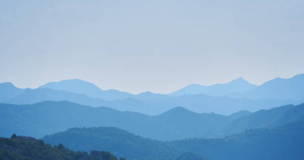 istock Mountain landscape with layers effects in blue haze 1397200676