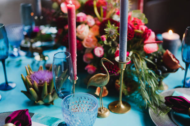 istock Table setting at the wedding reception. Floral compositions with beautiful flowers and greenery, candles, laying and plates on a decorated table. 1397201305