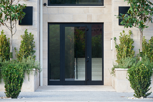 Black glass entrance door in modern building.