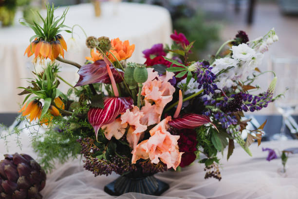 istock Table setting at the wedding reception. Floral compositions with beautiful flowers and greenery, candles, laying and plates on a decorated table. 1397201346