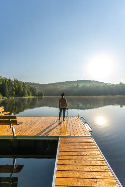 istock A woman on vacation by a lake. 1397202578