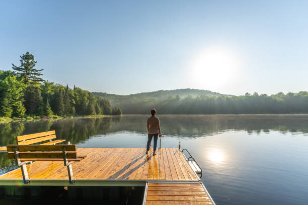 istock A woman on vacation by a lake. 1397202588