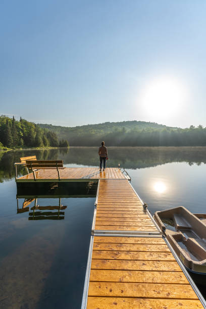 istock A woman on vacation by a lake. 1397202594