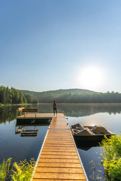 istock A woman on vacation by a lake. 1397202595