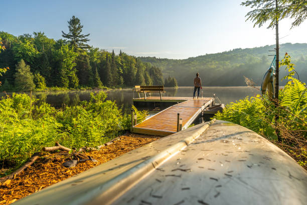 A woman on vacation by a lake.