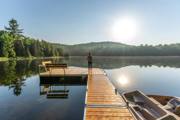 istock A woman on vacation by a lake. 1397202620