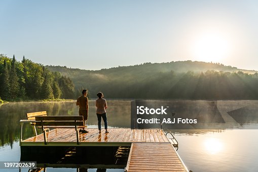 istock Couple on vacation by a lake. 1397202639