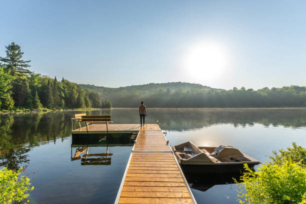 istock A woman on vacation by a lake. 1397202663