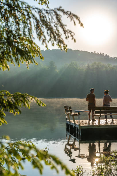 couple on vacation by a lake. - foto’s van oudere mannen stockfoto's en -beelden