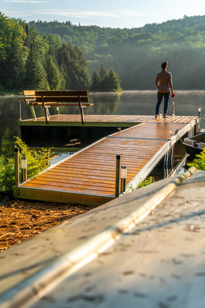 istock A woman on vacation by a lake. 1397202880