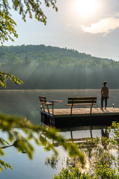 istock A woman on vacation by a lake. 1397202941