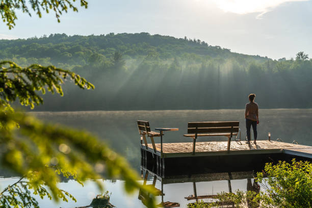 istock A woman on vacation by a lake. 1397202950