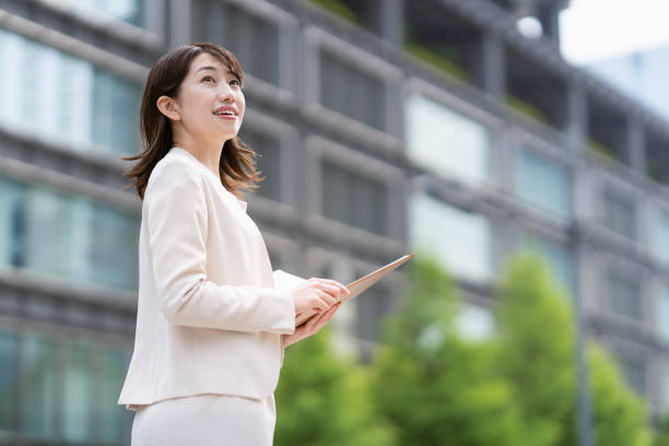 istock Business woman standing in the office district 1397203924