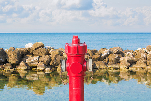 An improbable hydrant at the seaside - Plenty of water concept image