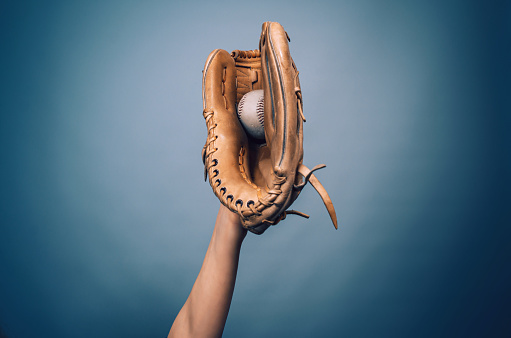 Hand in a leather baseball glove caught a ball