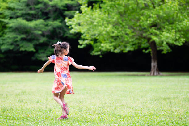 istock Girl playing in the field 1397208390