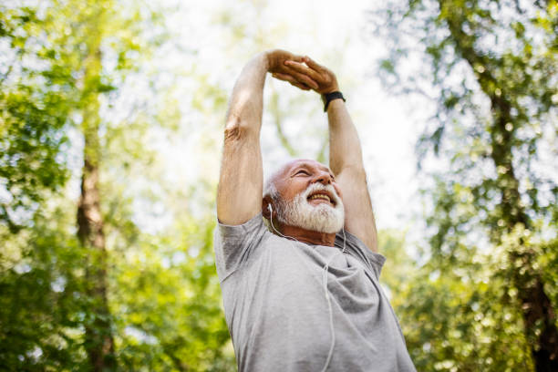 istock Senior man stretching hands in park 1397211963