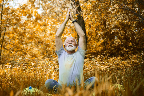 istock Senior Man in park doing yoga 1397212001