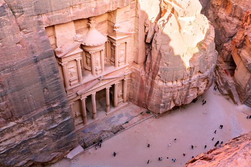 Top view of Al Khazneh - the treasury, ancient city of Petra, Jordan. Nabatean rock-cut temple of Hellenistic period of ancient Petra, originally known to Nabataeans as Raqmu - historical city