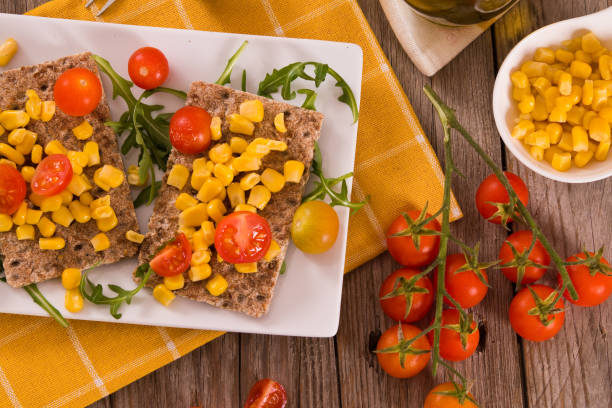 istock Crispy rye bread with sesame seeds, arugula and sweet corn. 1397218175