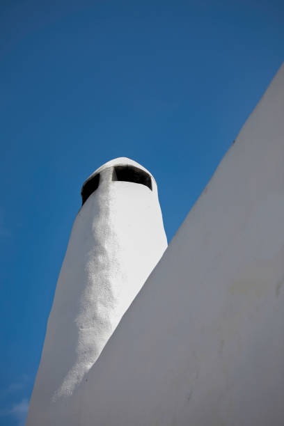 Greek Chimney Isolated. Copy Space. Whitewashed chimney in Syros Island . Blue sky in the background. Stock Image. phallus shaped stock pictures, royalty-free photos & images