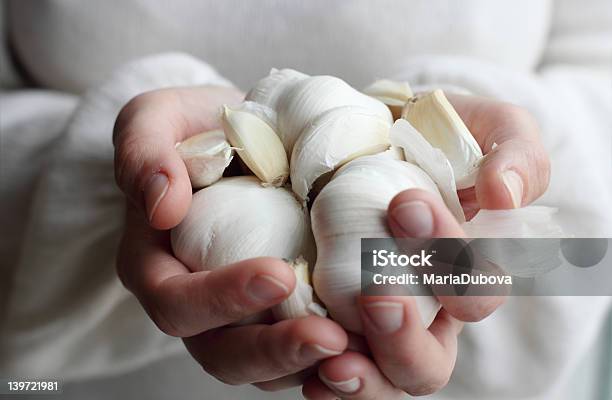Woman Holding Garlic Stock Photo - Download Image Now - Garlic, Eating, Women