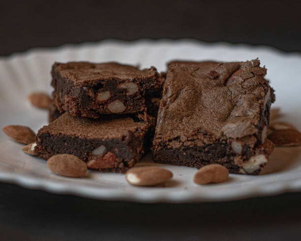 Brownies in white plate with almonds