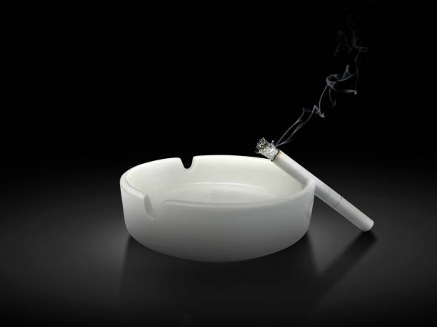 istock White ashtray and cigarette on black background 1397220835