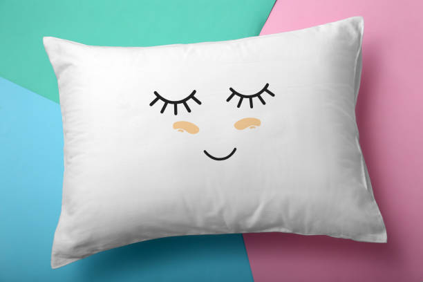 istock Soft pillow with cute face on color background, top view 1397221780