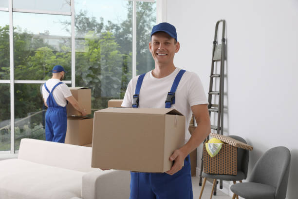 istock Moving service employees with cardboard boxes in room 1397221926