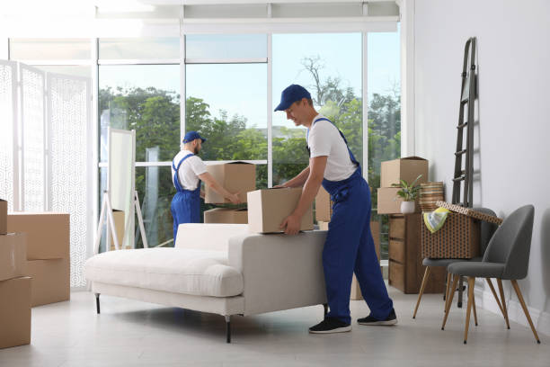 istock Moving service employees with cardboard boxes in room 1397222006