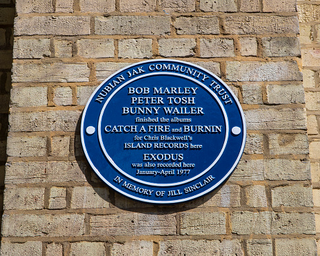 London, UK - May 5th 2022: A plaque on Basing Street in London, UK, marking the location where Bob Marley, Peter Tosh and Bunny Wailer recorded music.
