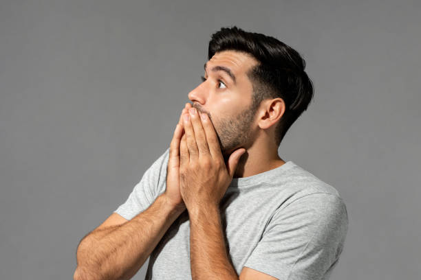 istock Surprised beard Caucasian man covering mouth on gray isolated background in studio 1397224653