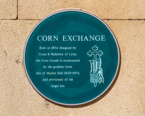 Norfolk, UK - April 8th 2022: A plaque located on the exterior of the Corn Exchange building on Tuesday Market Place in Kings Lynn in Norfolk, UK, detailing the history of the building.