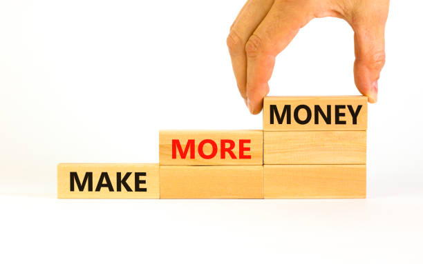 istock Make more money symbol. Concept words Make more money on blocks on beautiful white table white background. Businessman hand. Business, make more money concept. Copy space. 1397228620