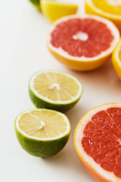 Closeup image of different sliced citrus fruits such as grapefruit, orange, lemon and lime