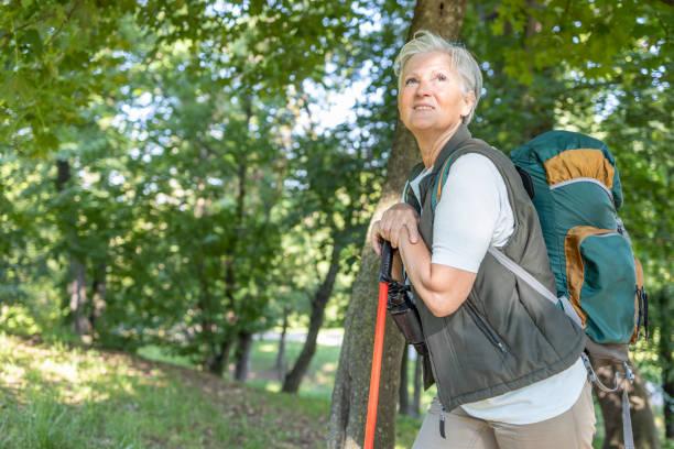 istock Mature woman leaning onto a trekking pole during a hike 1397232444