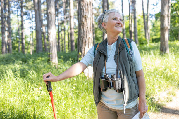 istock Woman leaning onto trekking pole during a hike and smiling 1397232446
