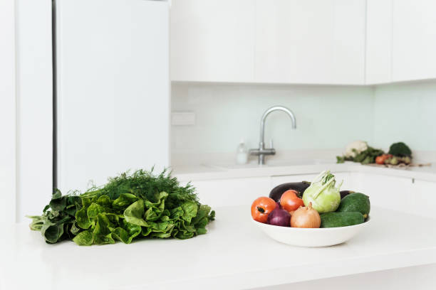 istock Vegetables and herbs for vegetarian meal on white kitchen table 1397232458